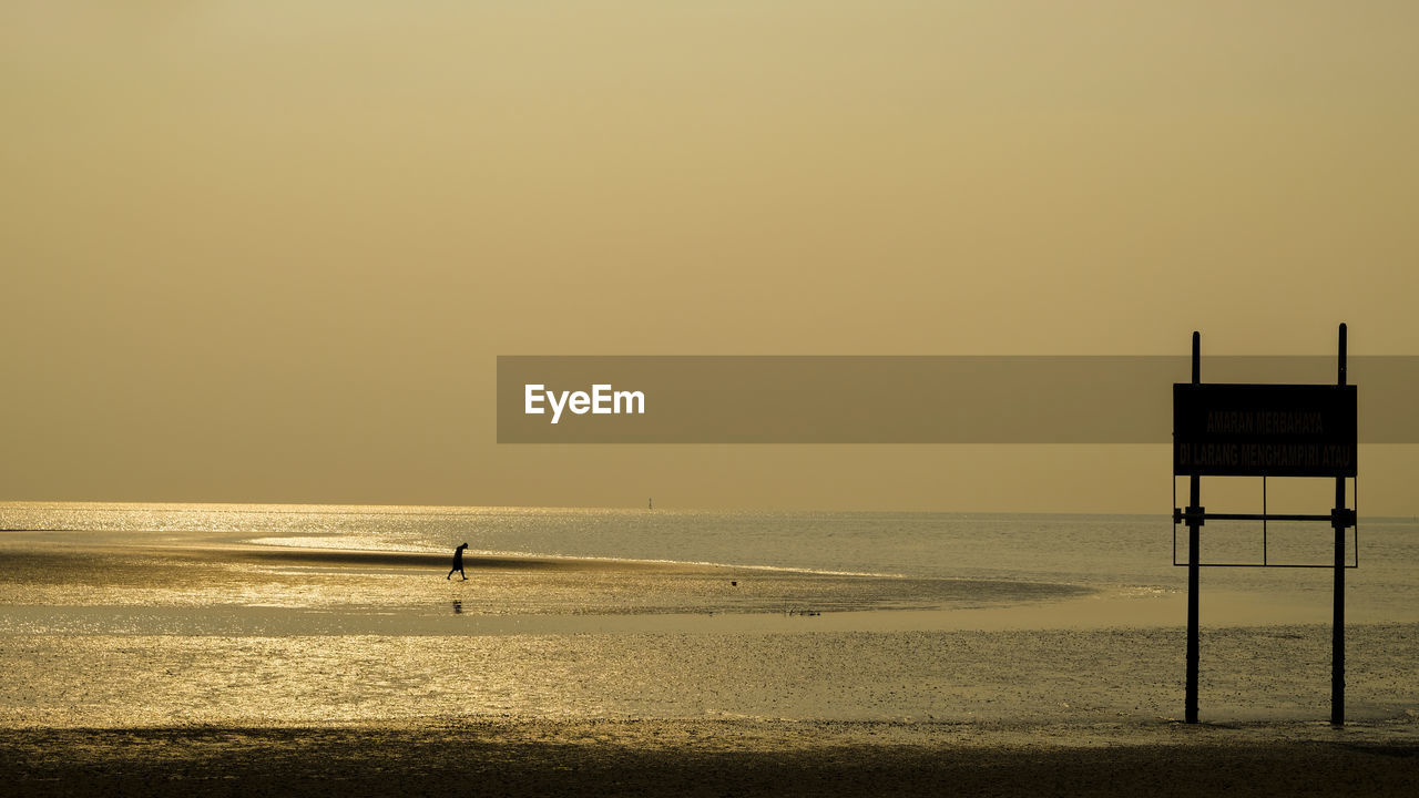 Scenic view of sea against clear sky during sunset