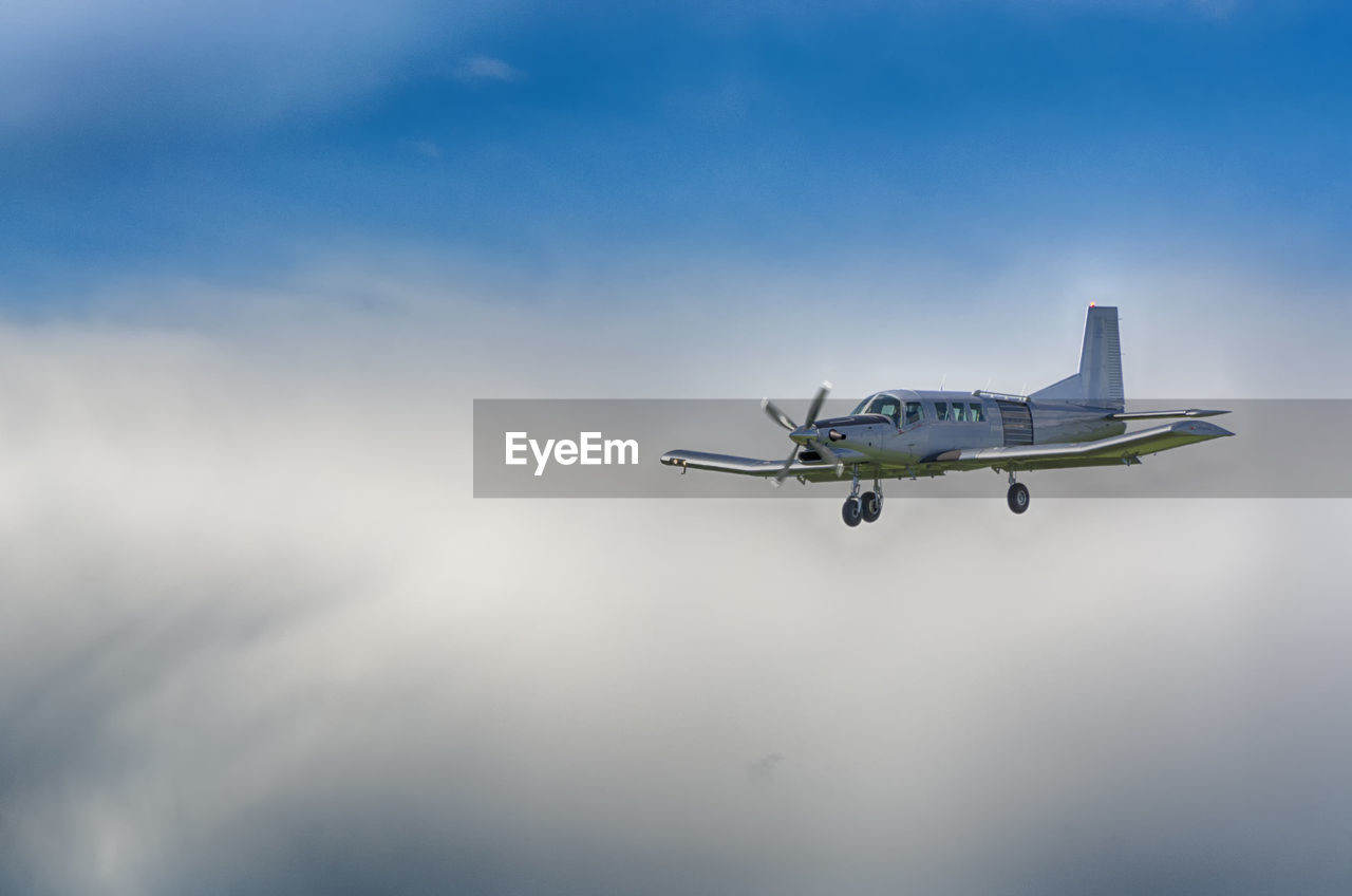 Airplane flying in cloudy sky