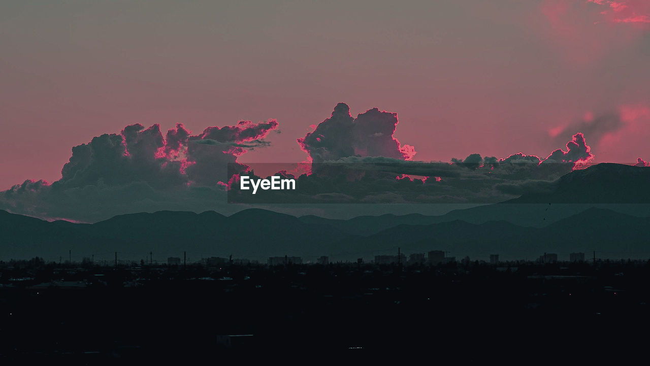 SILHOUETTE MOUNTAINS AGAINST SKY AT SUNSET