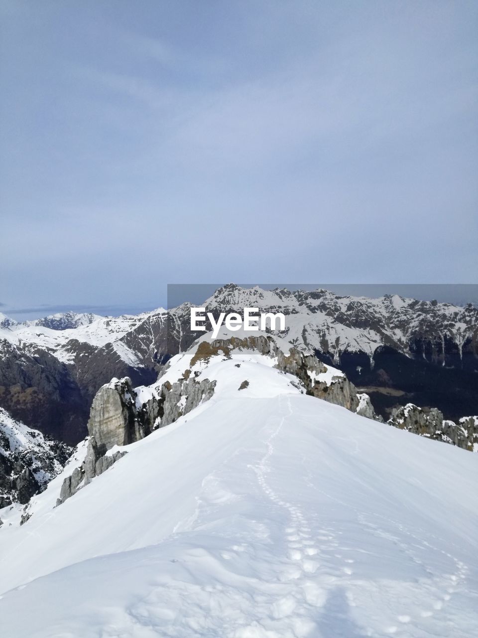 Scenic view of snow covered mountains against sky