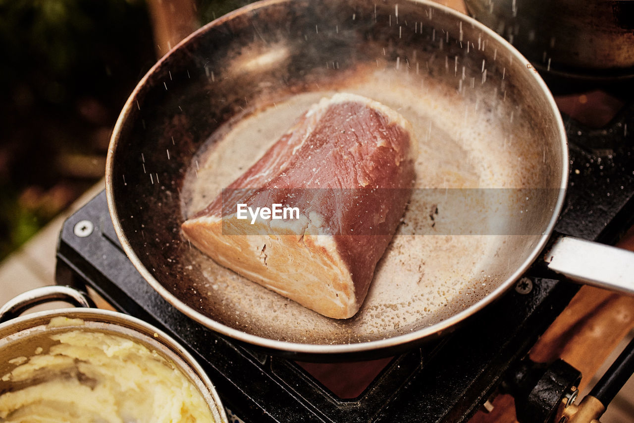 Close-up of meat in cooking pan