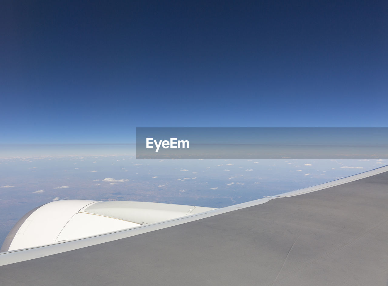 Cropped image of airplane flying over sea