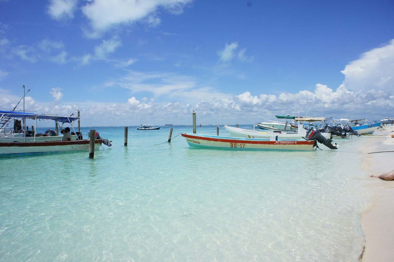 Boats moored at tropical beach