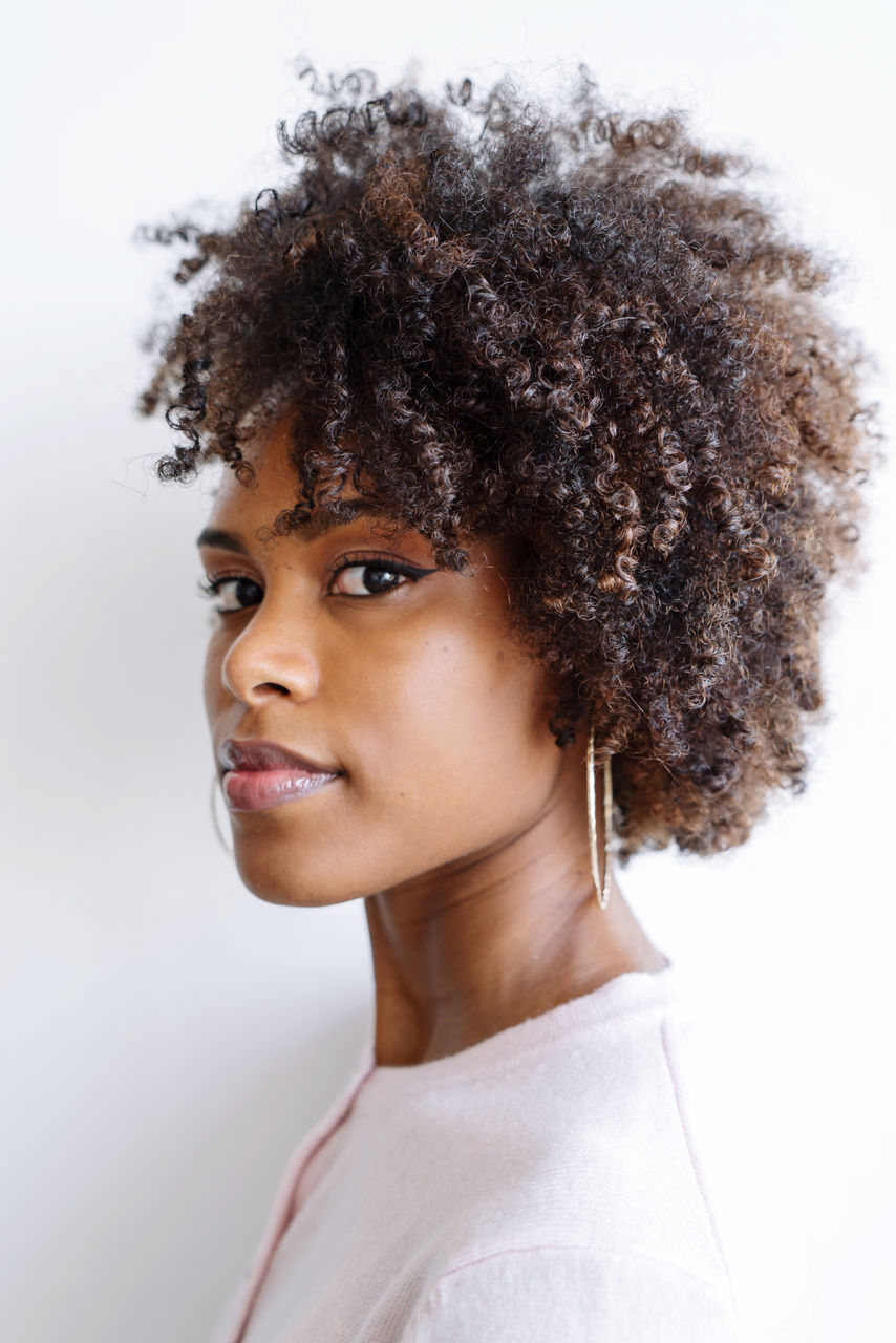 Portrait of a beautiful black woman with afro on the white background