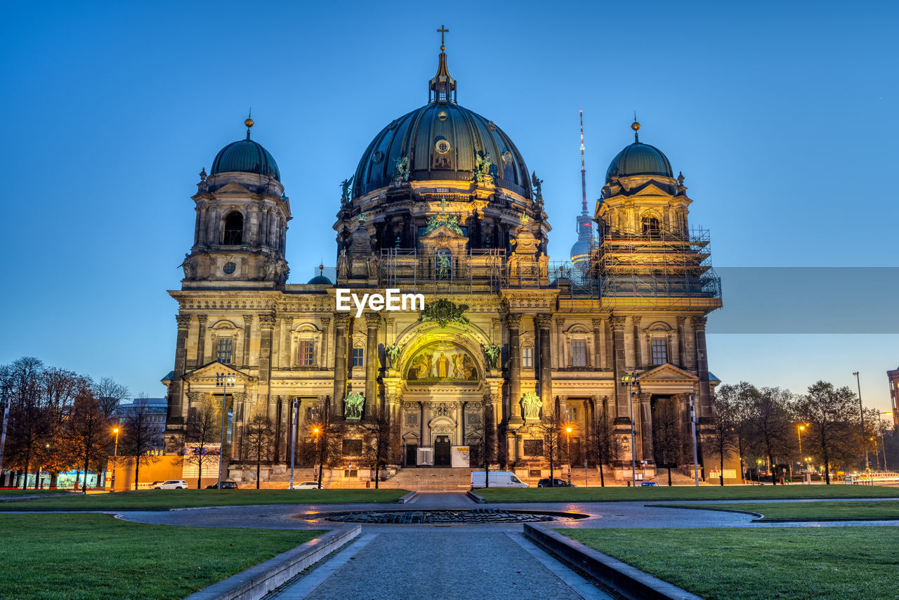 The illuminated berlin carhedral, germany, just before sunrise