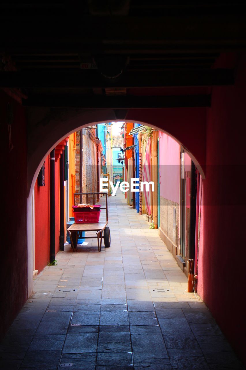 Alleyway through an arch on burano island, venice, italy 