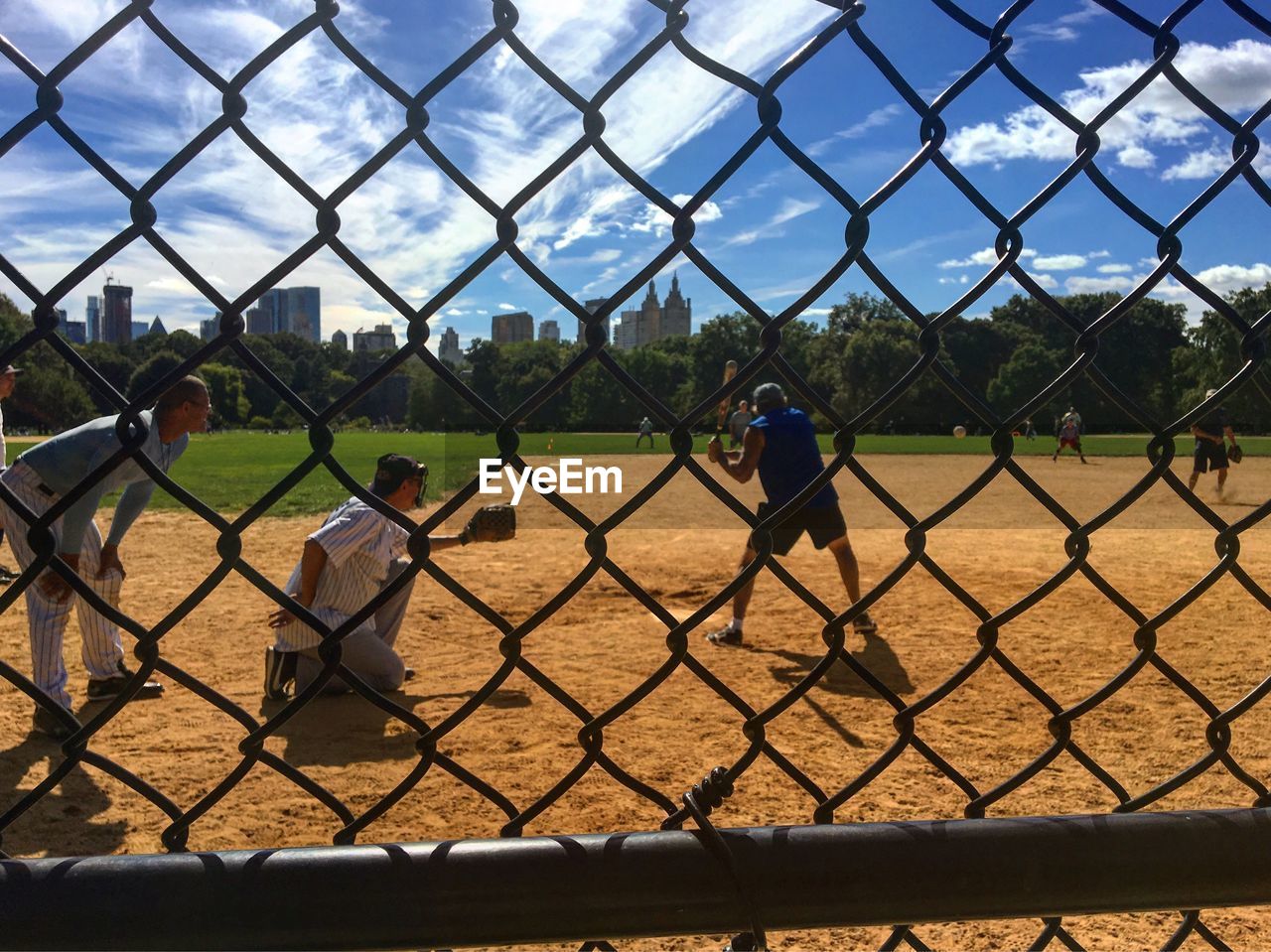 CLOSE-UP OF CHAINLINK FENCE AGAINST SKY