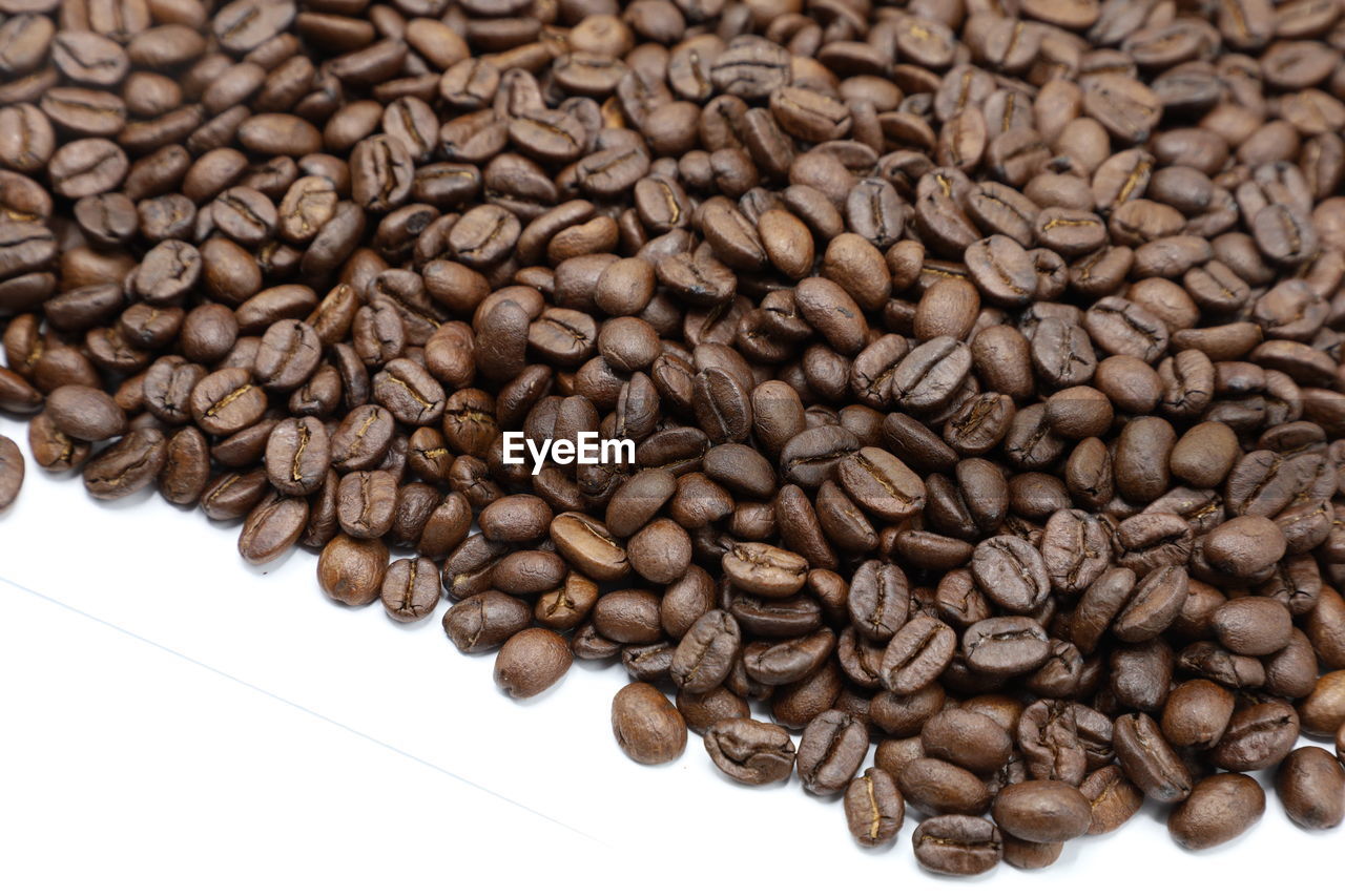 HIGH ANGLE VIEW OF COFFEE BEANS ON WHITE BACKGROUND