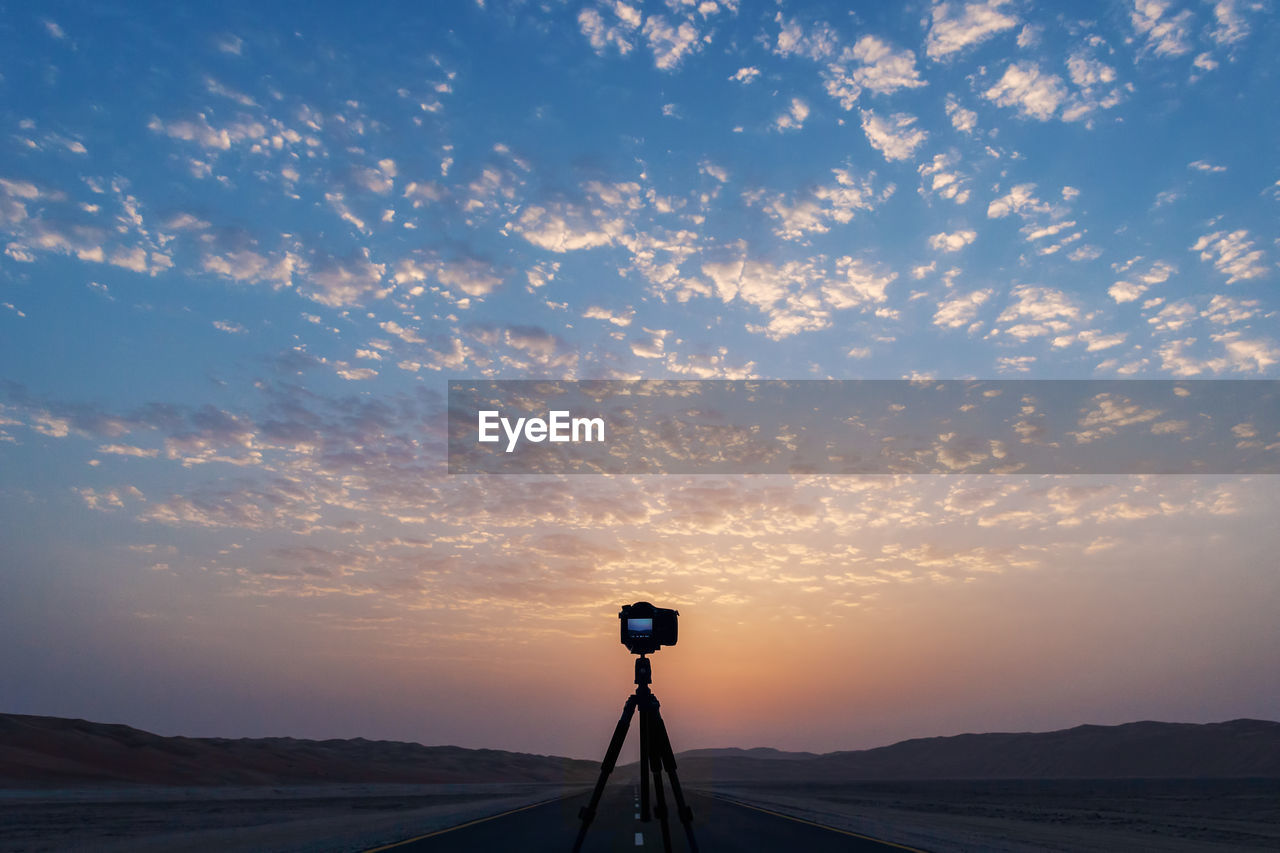 Camera against sky during sunset