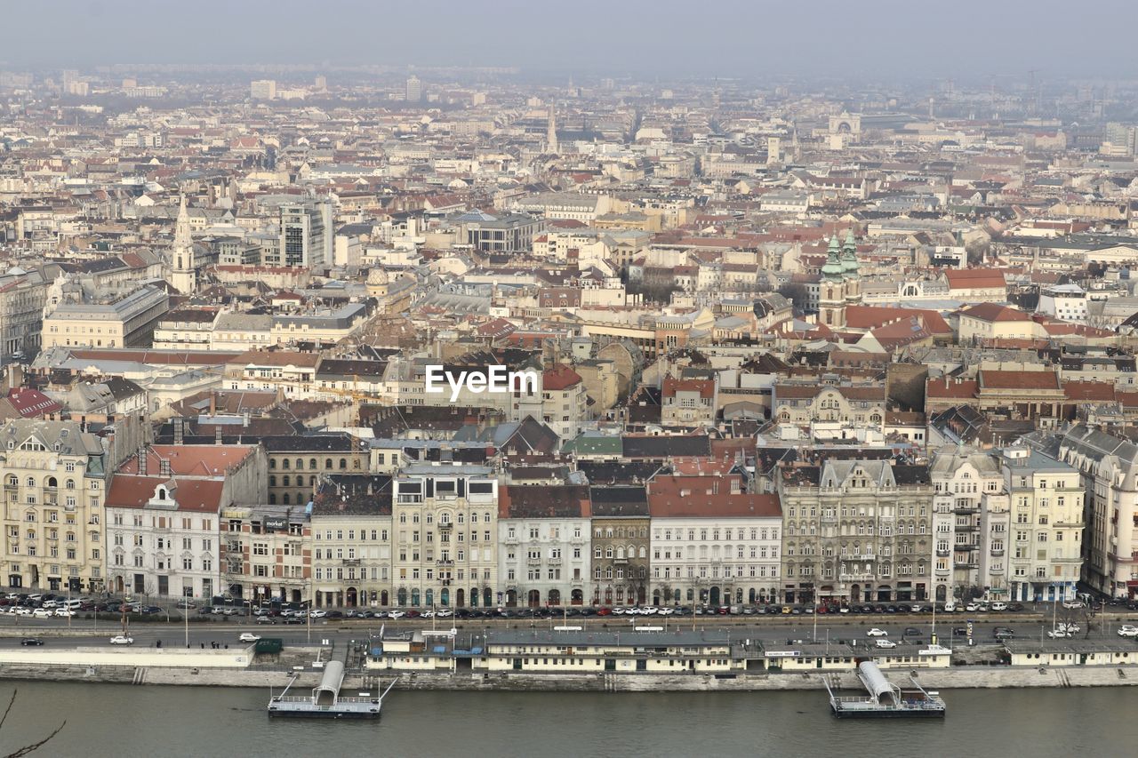 Aerial view of river by buildings in city