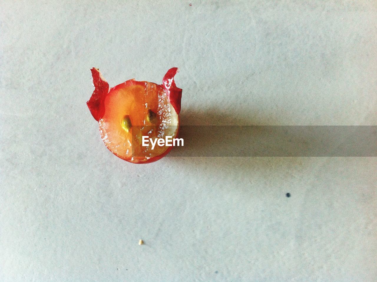 CLOSE-UP OF RED FRUIT ON LEAF