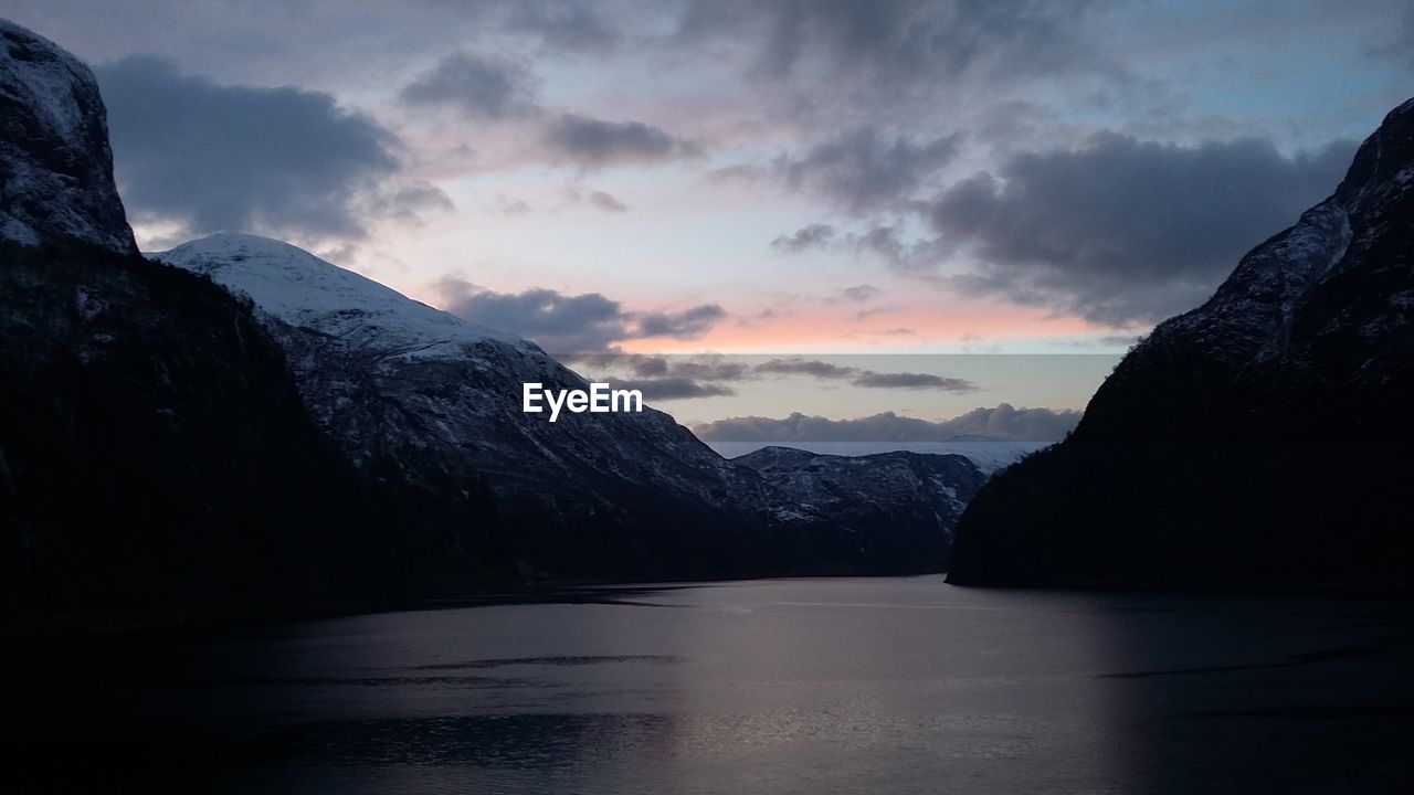 Scenic view of mountains against cloudy sky