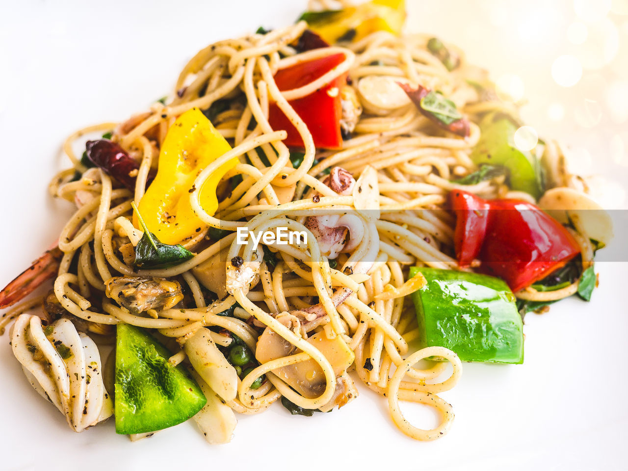 Spaghetti black olive pepper with seafoods / isolated