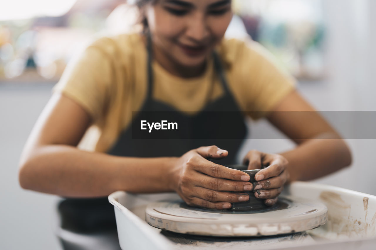 Female potter working at home