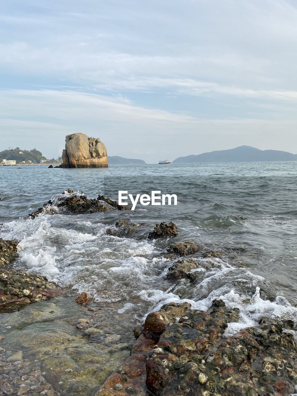 Scenic view of rocks in sea against sky