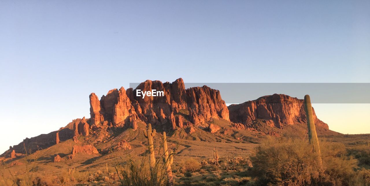 Rock formations on landscape against clear sky