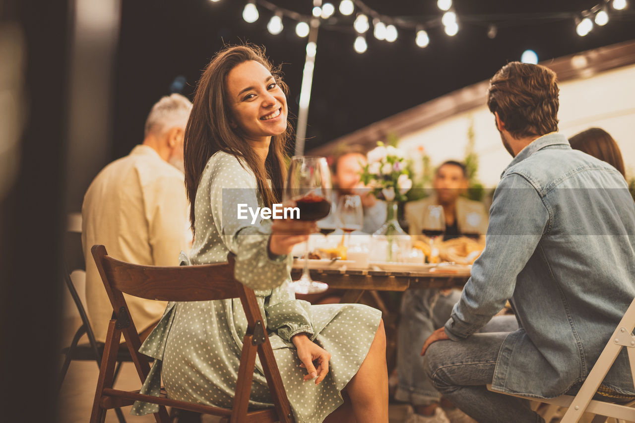 Portrait of young woman sitting at restaurant