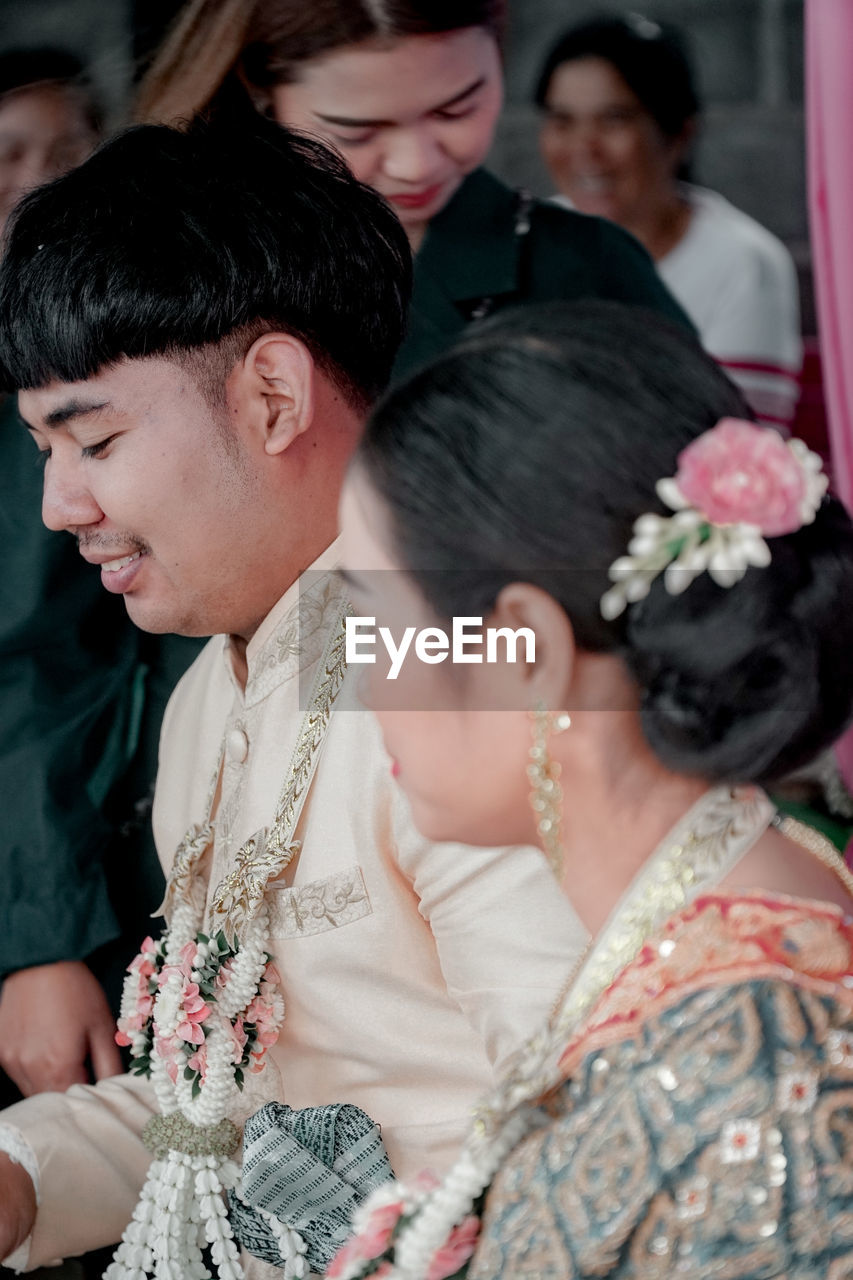 COUPLE KISSING IN A TRADITIONAL TEMPLE