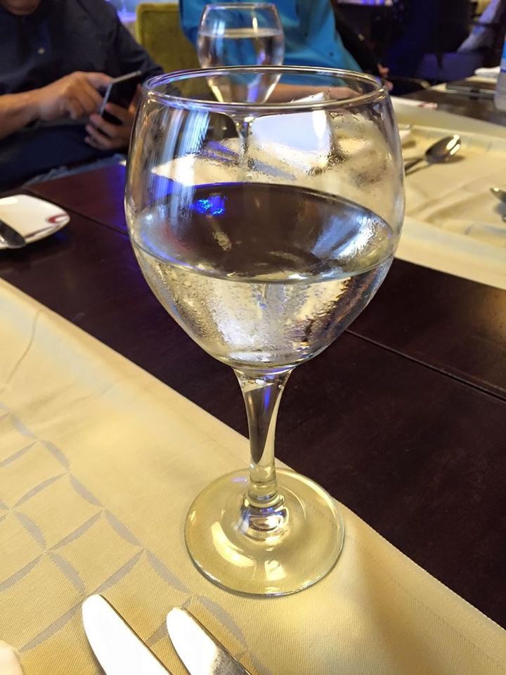 CLOSE-UP OF WINE GLASSES ON TABLE