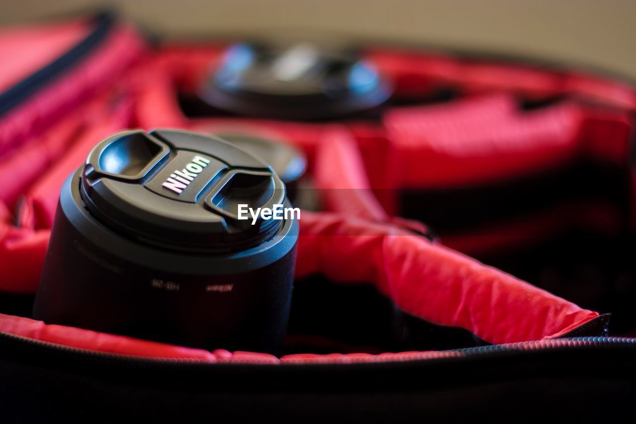 CLOSE-UP OF DIGITAL CAMERA ON TABLE WITH EYEGLASSES