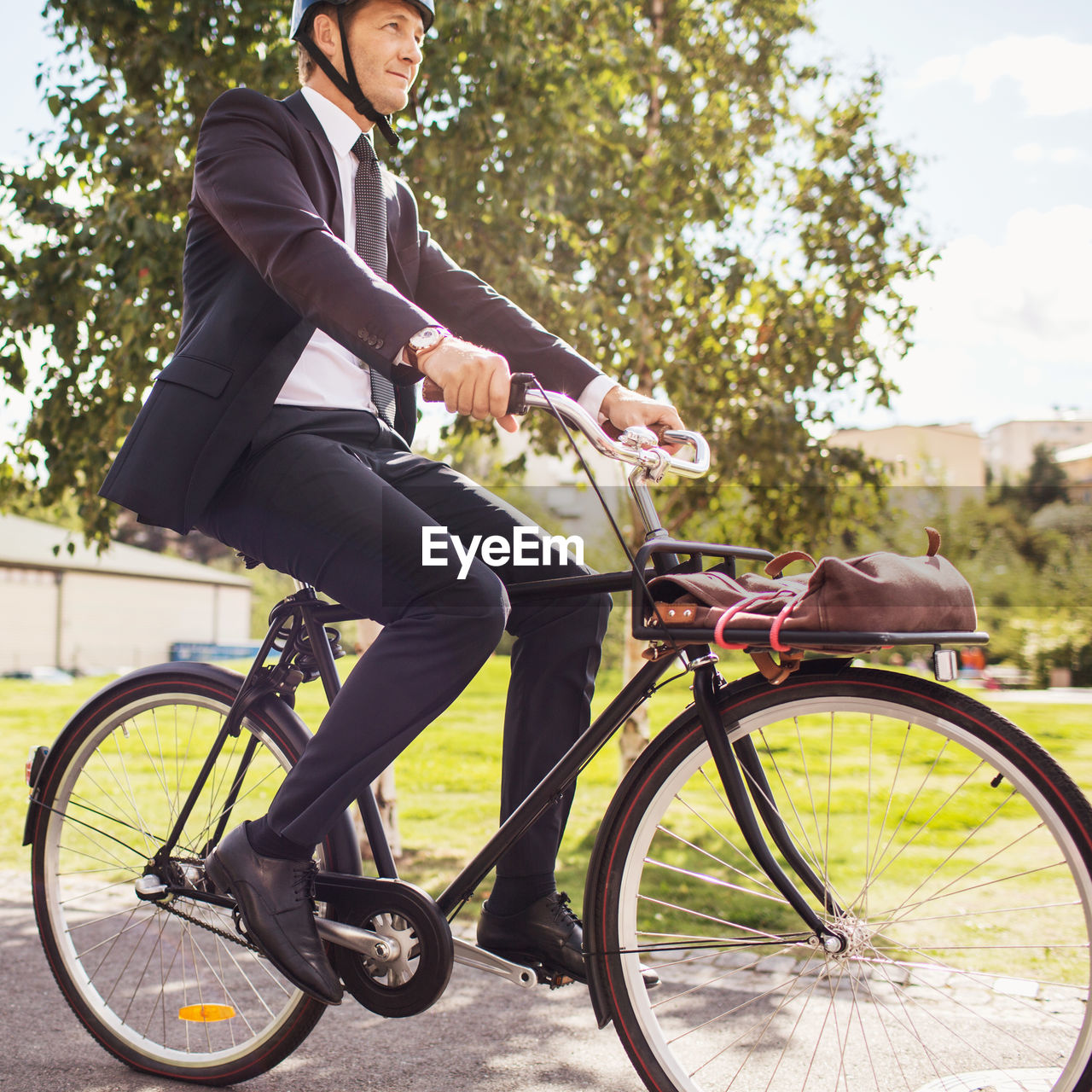 Businessman riding bicycle on street