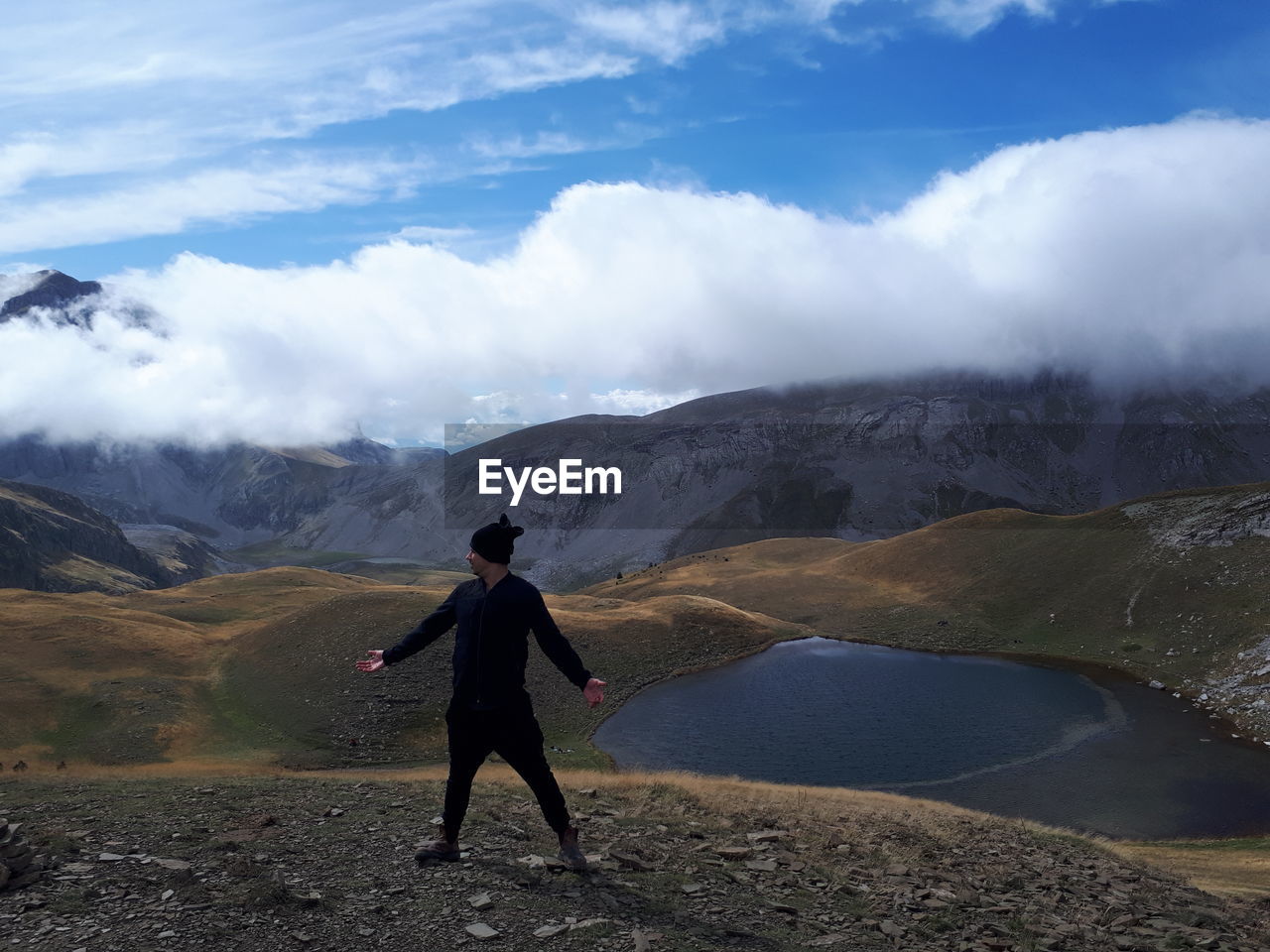 Full length of man standing on mountain against sky