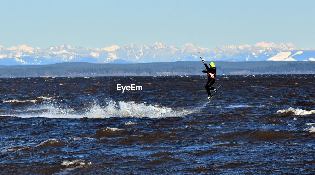 WOMAN JUMPING ON BEACH