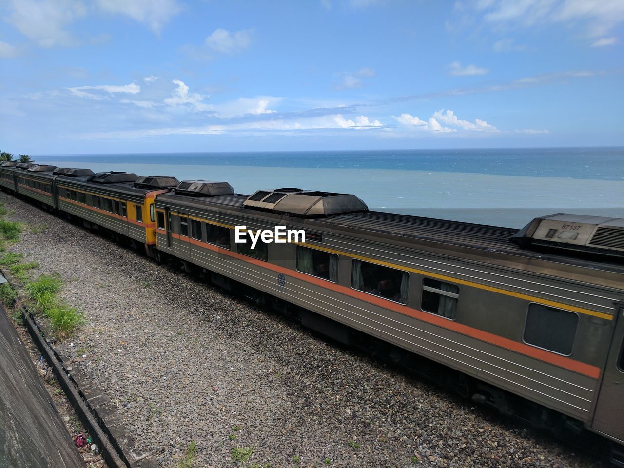 Train by sea against sky