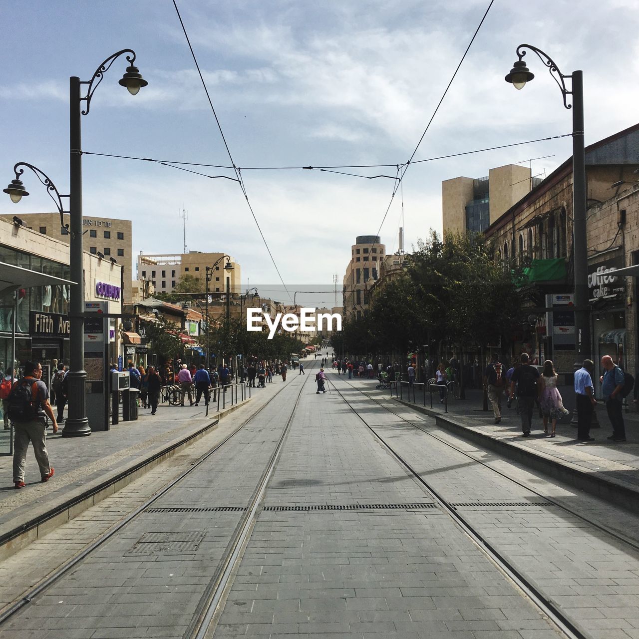 PEOPLE WALKING ON STREET IN CITY