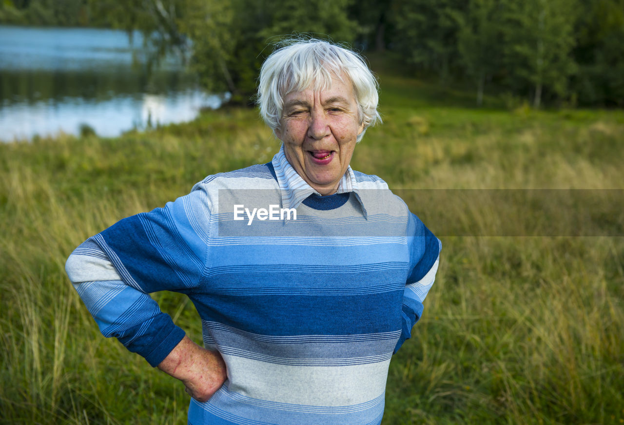 Portrait of senior woman standing at park