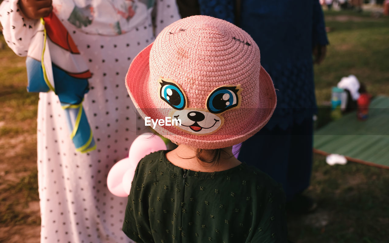 childhood, representation, child, focus on foreground, clothing, one person, day, cartoon, celebration, toy, animal representation, men, nature, outdoors, fun, person, hat, disguise, mask, mask - disguise, standing, front view, costume, human representation