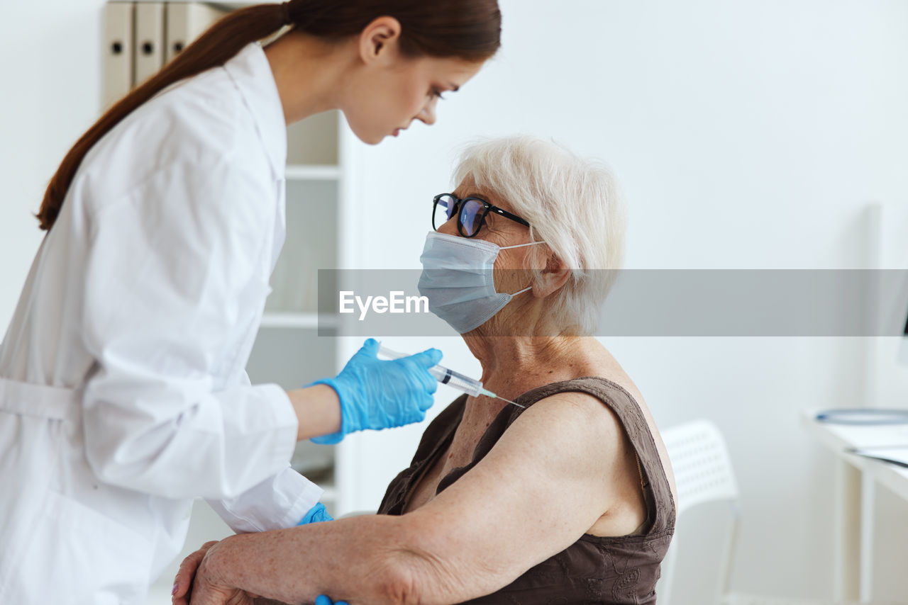 Midsection of woman wearing mask