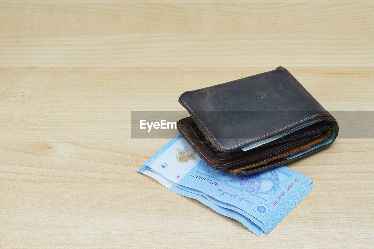 Close-up of money and wallet on table