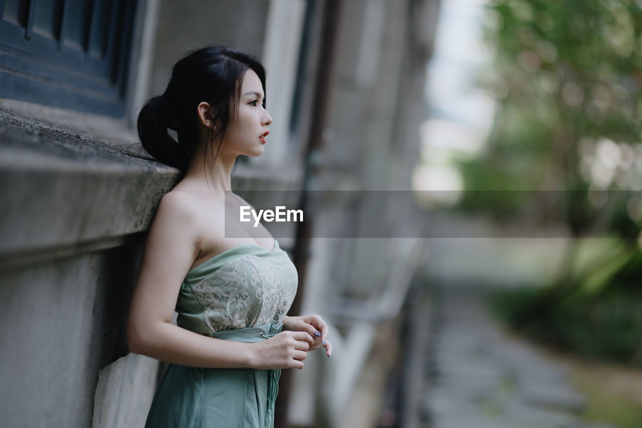 portrait of young woman standing outdoors