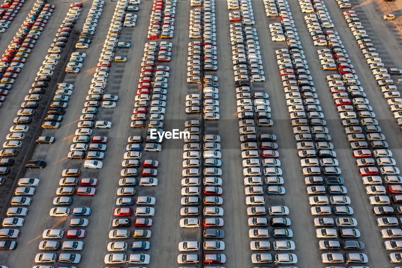 Aerial view of brand new cars at the logistics center, near the factory. car parking lot.