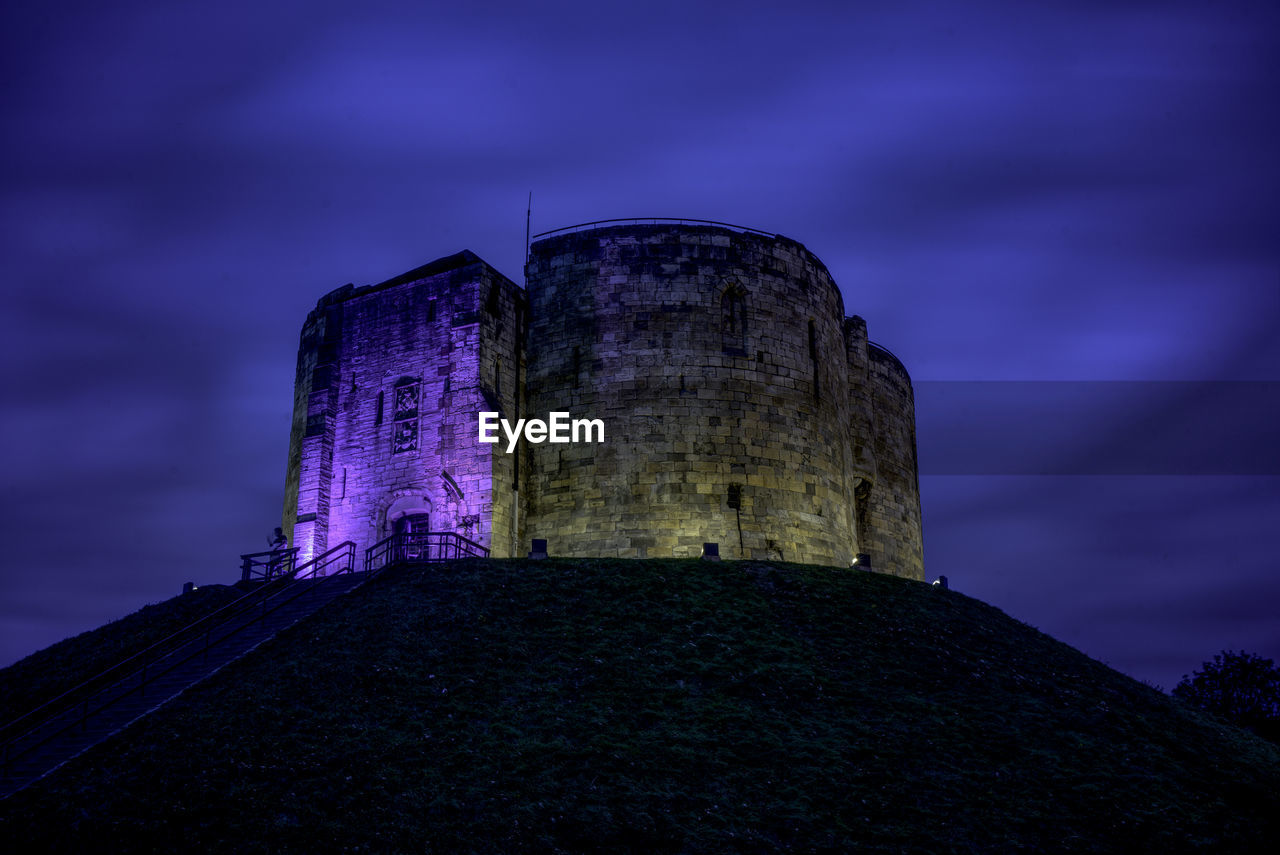 Low angle view of historic building against sky at night