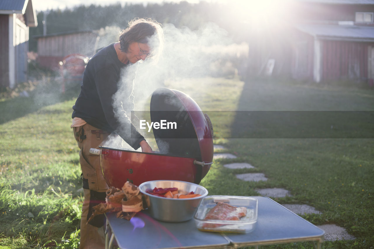 Woman having grill in garden