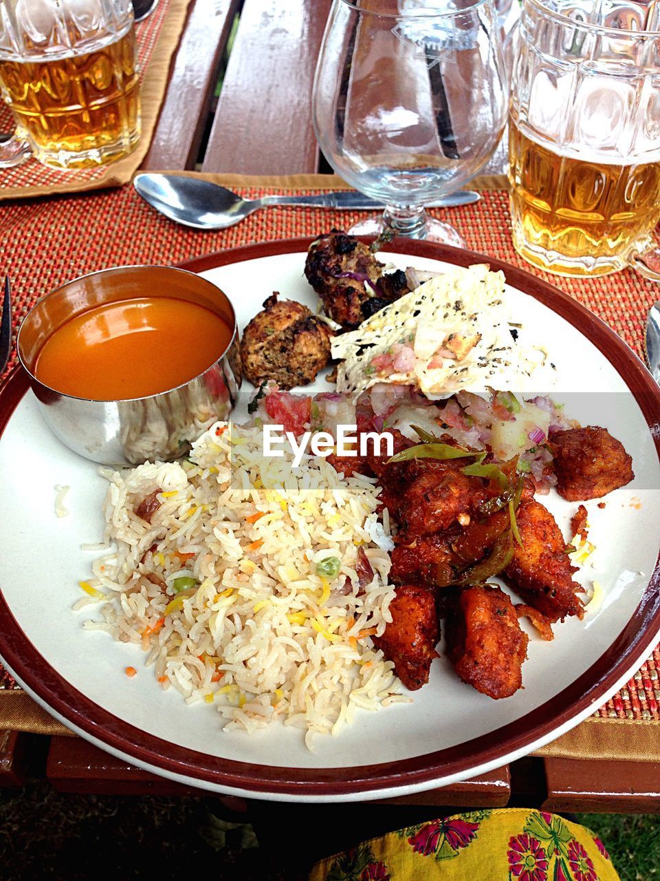 High angle view of fresh meal served with beer on table
