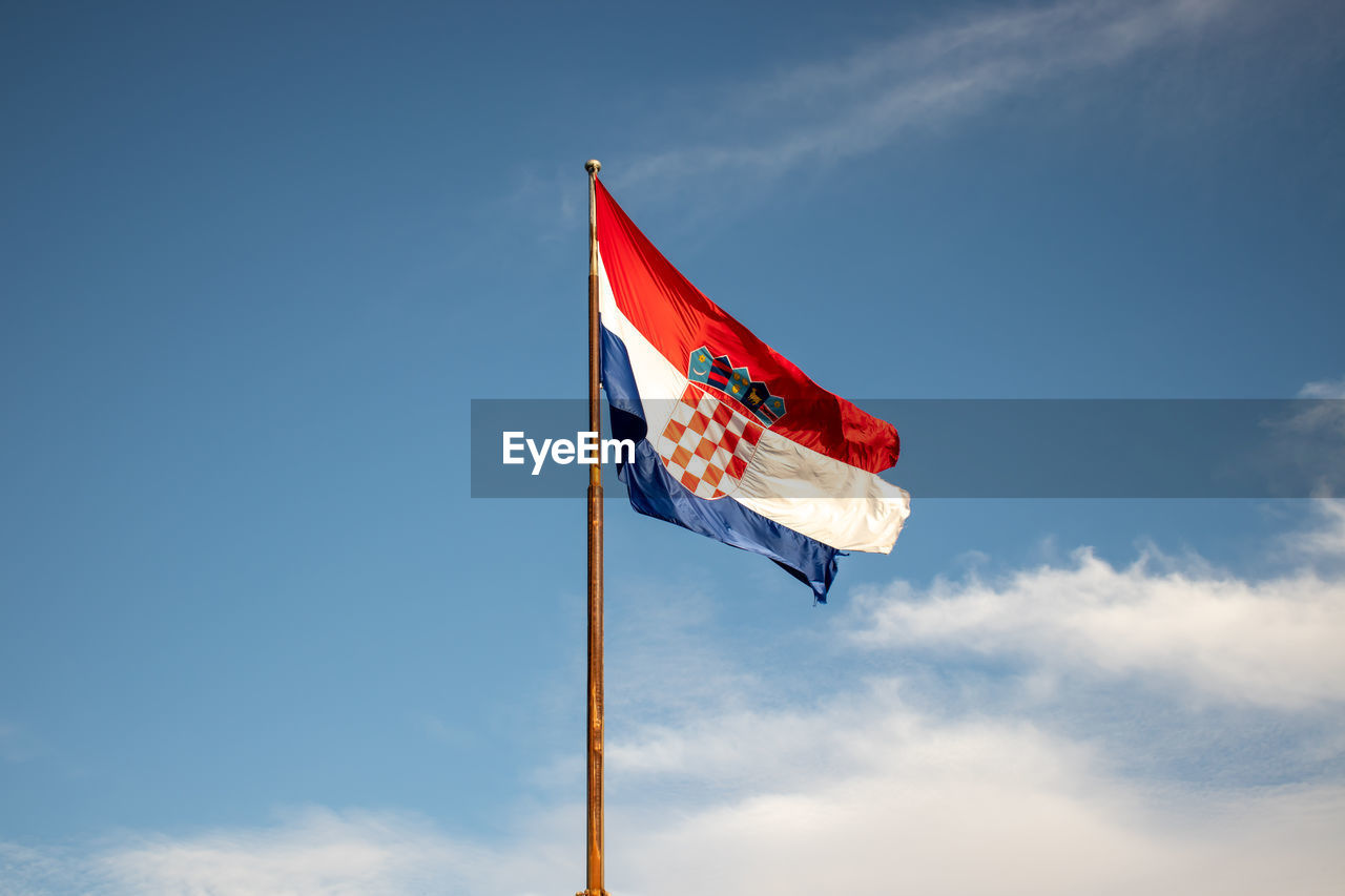 Low angle view of flag against sky