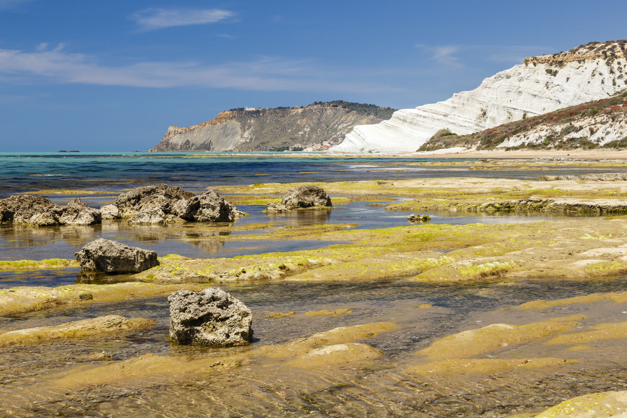 Scenic view of sea and mountains against sky