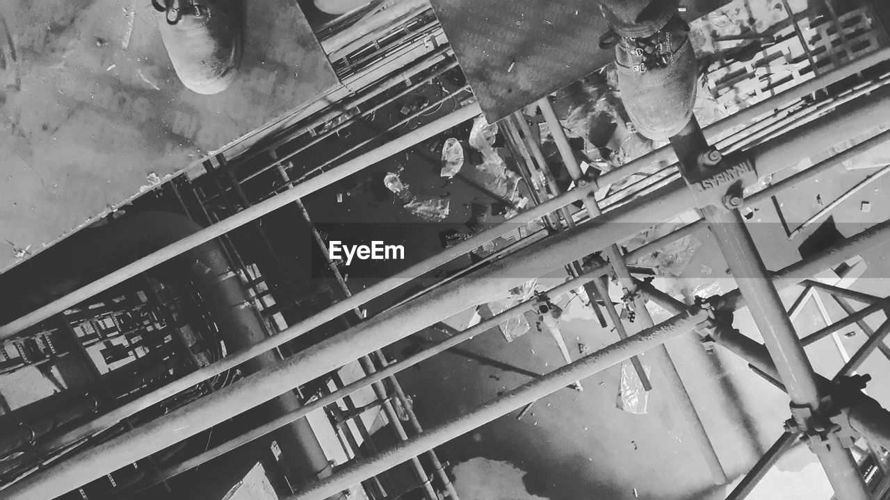 Low section of man standing on scaffolding at construction site