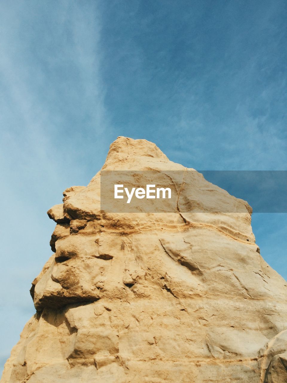 Low angle view of rock formation against blue sky