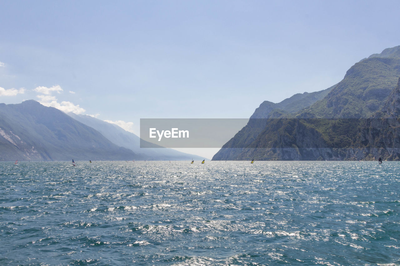 Scenic view of sea and mountains against sky