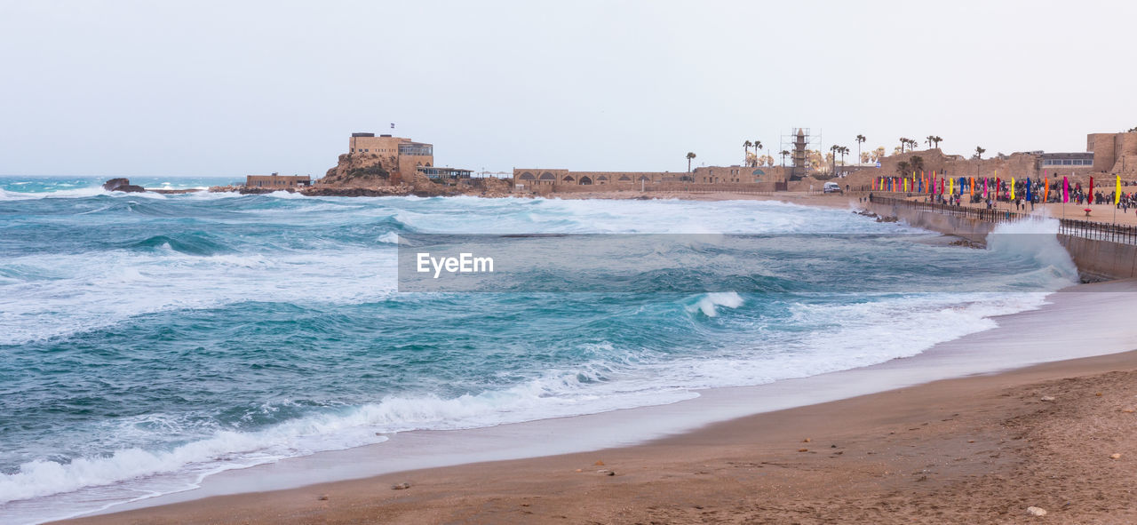 Panoramic view of beach against clear sky