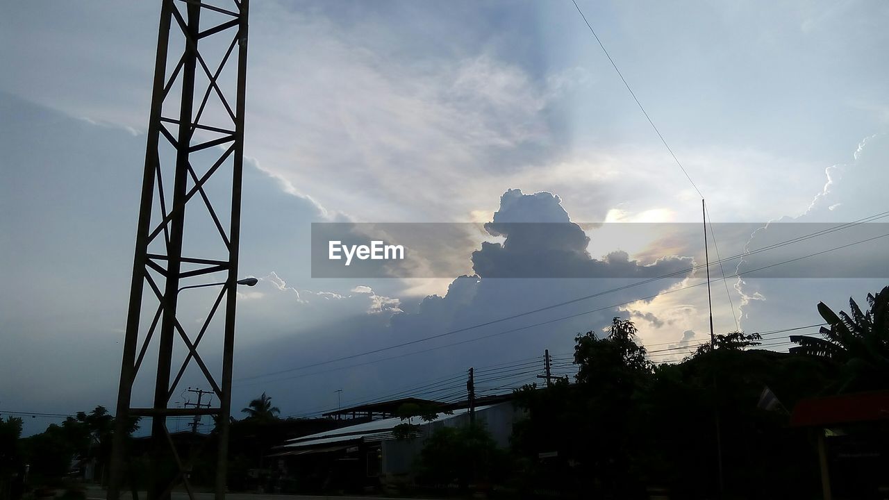 POWER LINES AGAINST CLOUDY SKY