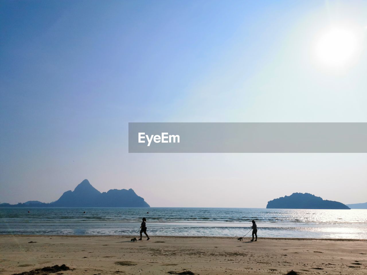 PEOPLE ON BEACH AGAINST SKY