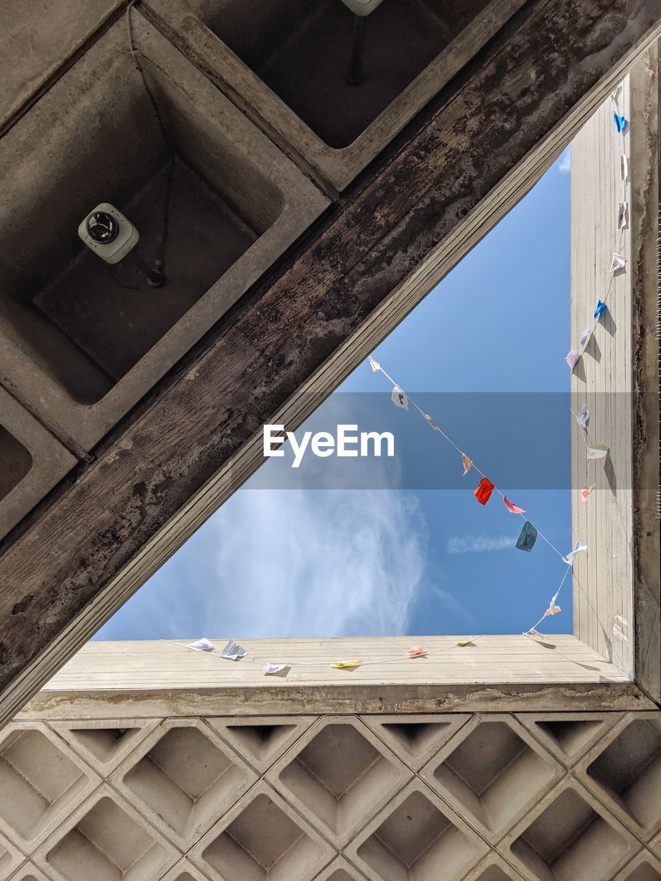 Low angle view of the sky through an opening in a building, geometric aesthetics