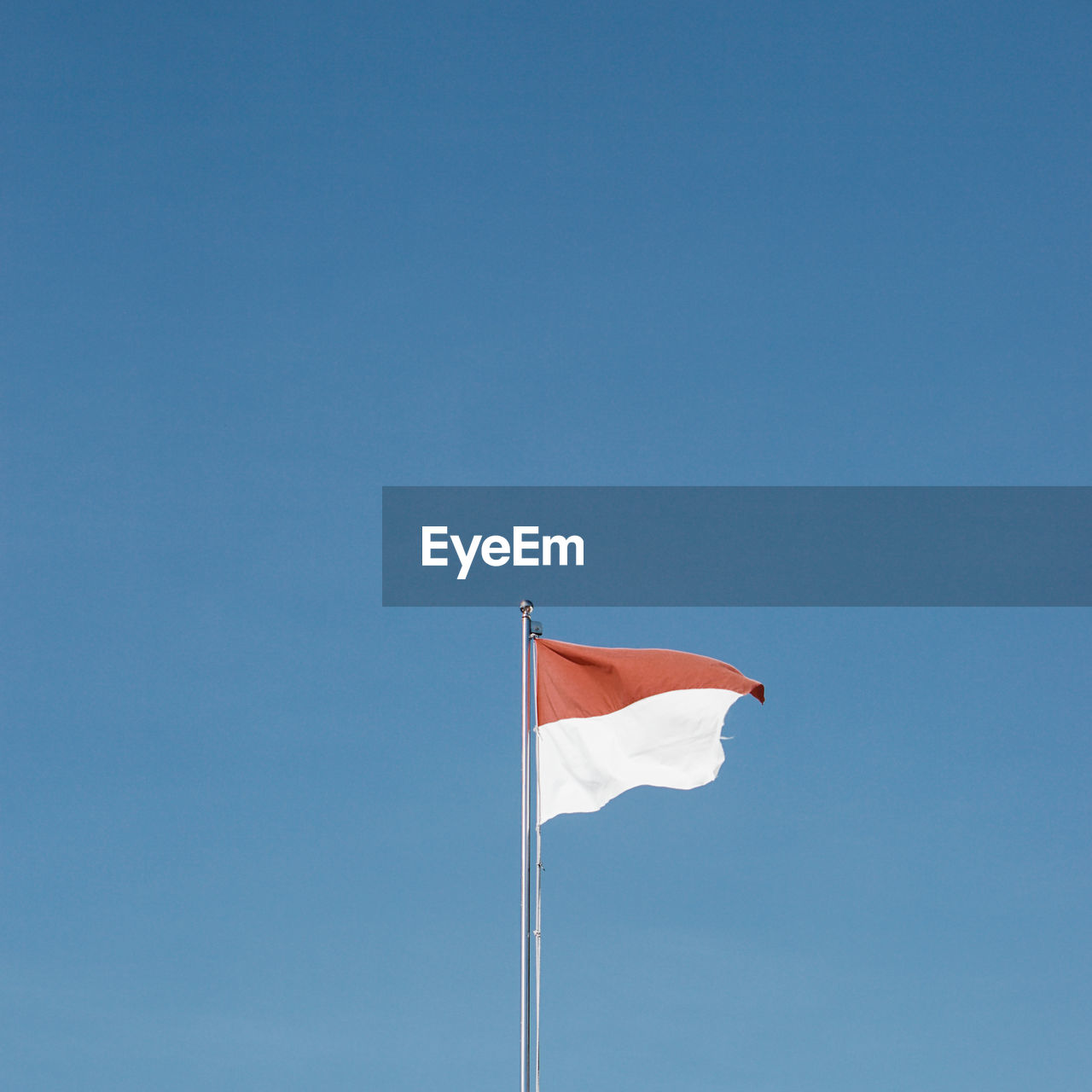 LOW ANGLE VIEW OF FLAG AGAINST CLEAR SKY