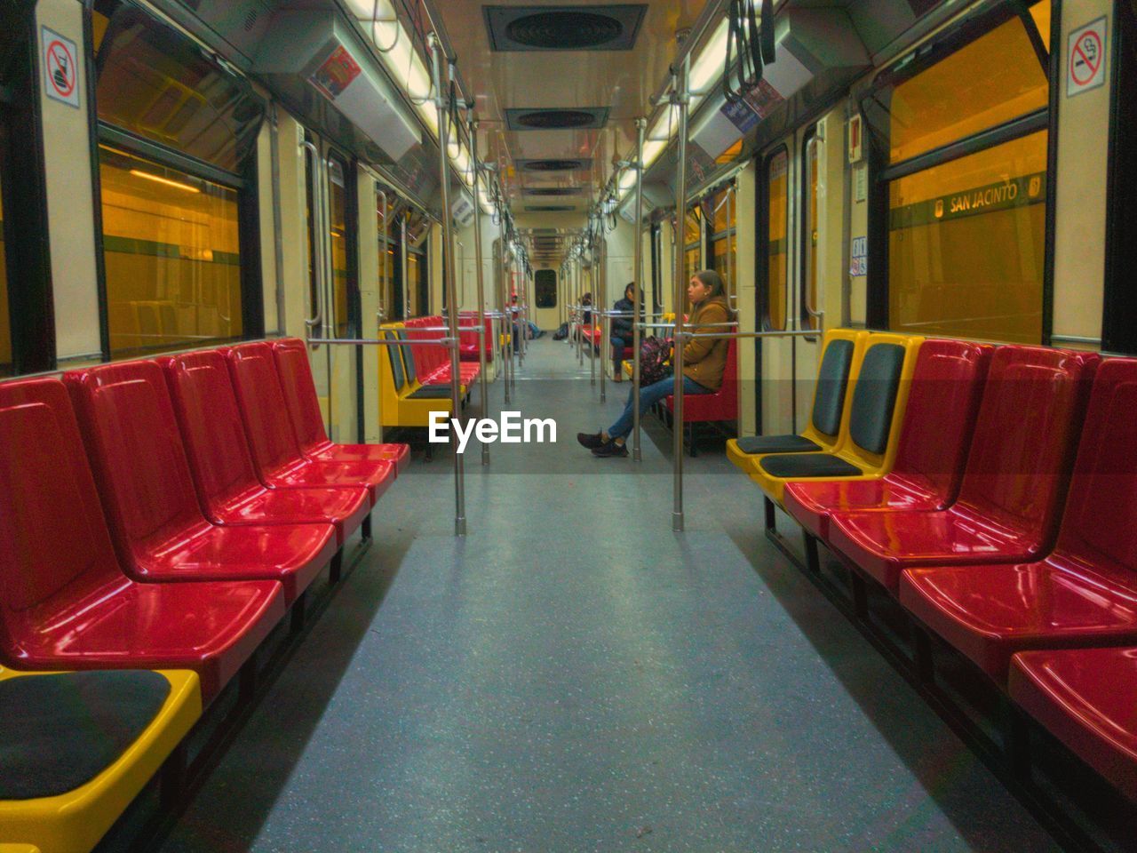 REAR VIEW OF TRAIN IN EMPTY SEATS IN SUBWAY