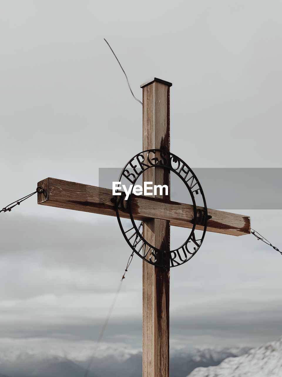 Low angle view of wooden cross against sky